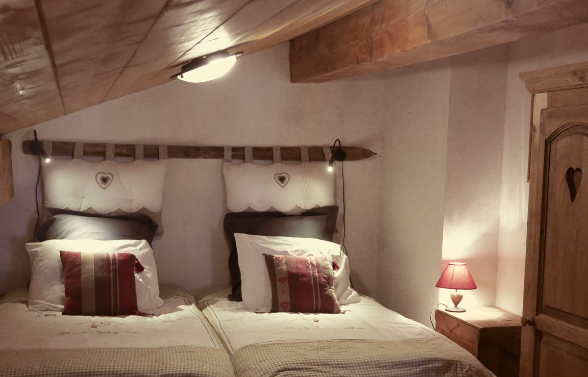 Bedroom with two beds and wood panelling