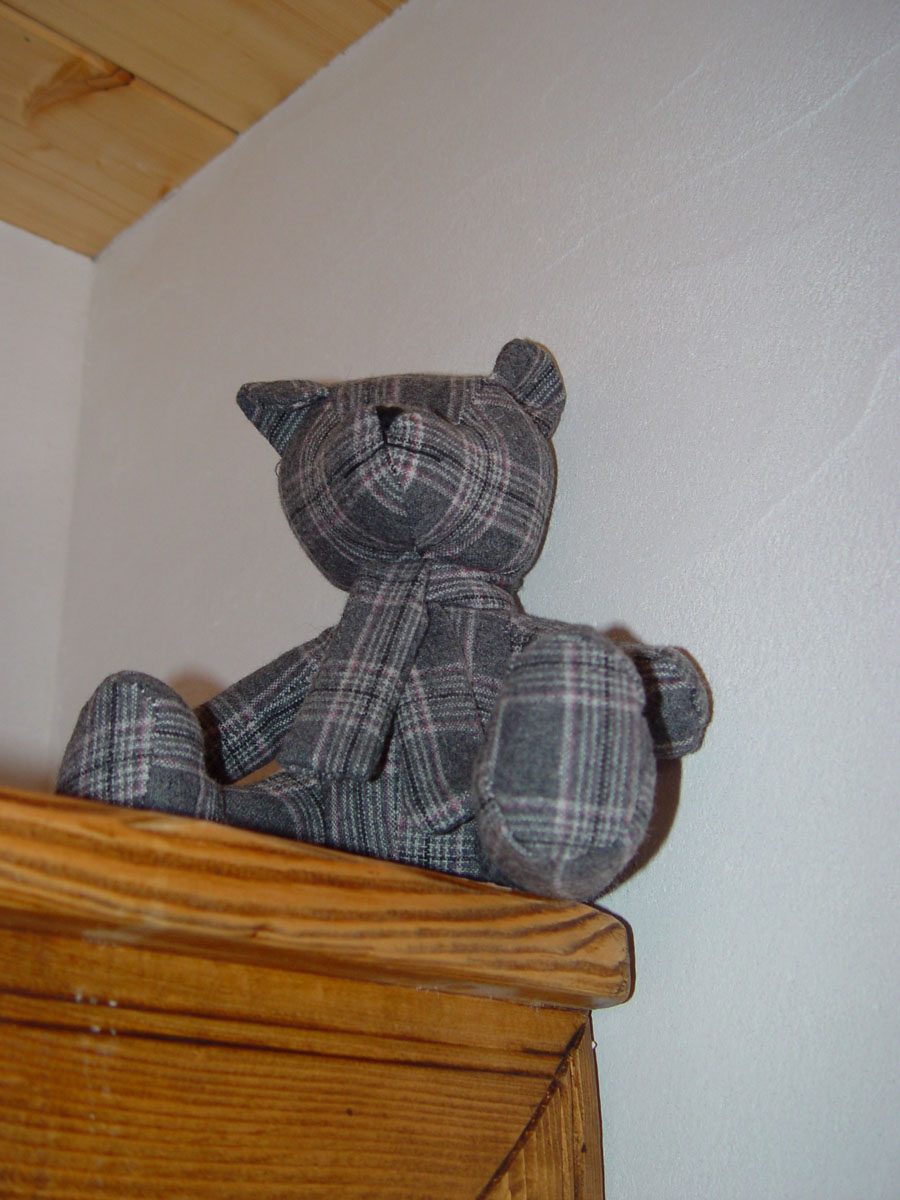 Fabric teddy bear on a chest of drawers