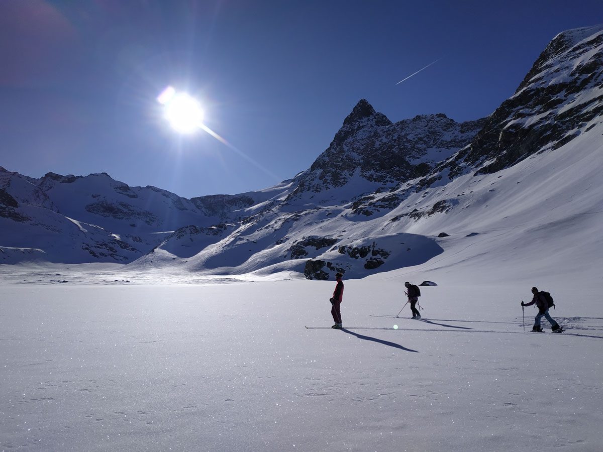 Ski tourers under the winter sun in Bessans